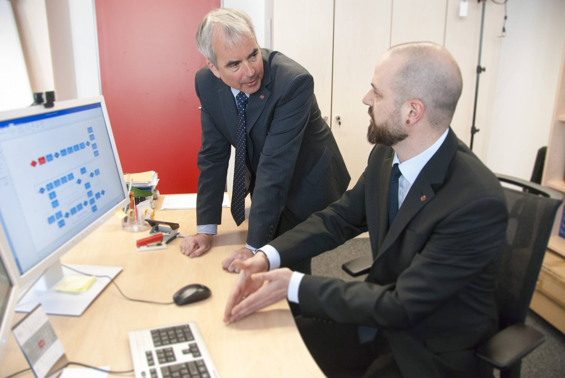 Zwei Mitarbeiter vor einem PC. Foto: Markus Wangler