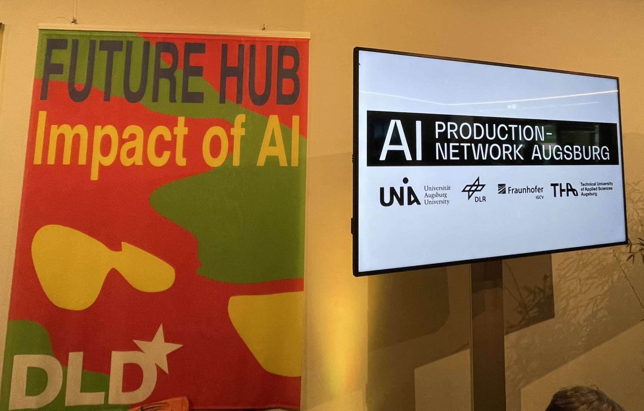 Logos von DLD Future Hub 2025 und KI-Produktionsnetzwerk Augsburg