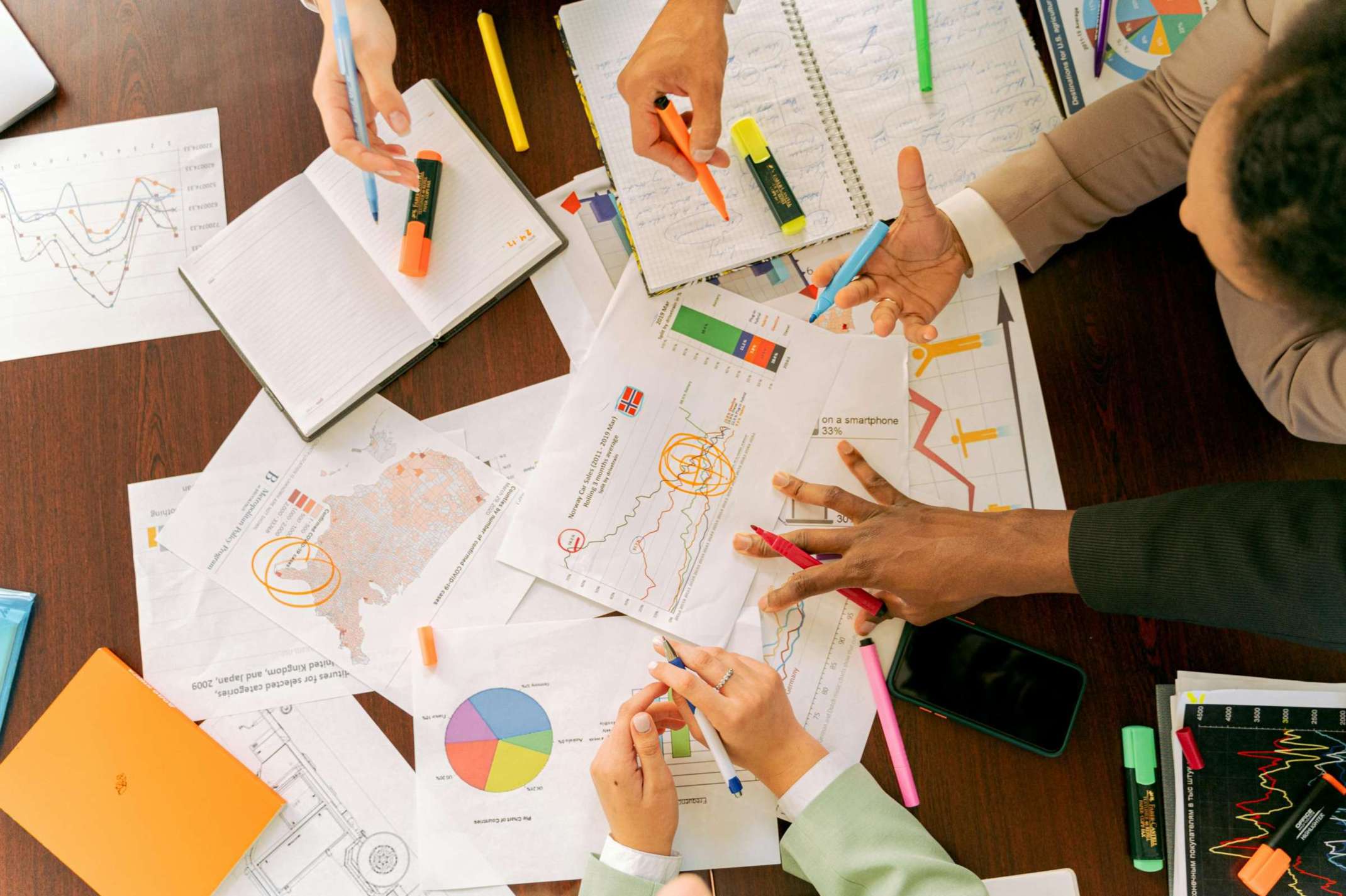 Business professionals collaborating over charts and data in a conference room