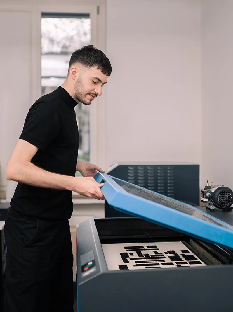 A person is working on a laser printer